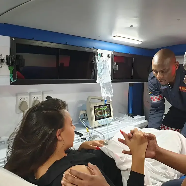 Paramedic team treating patient inside ambulance