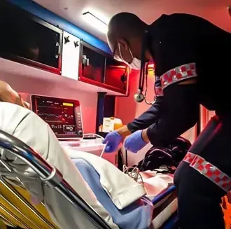 paramedic assisting a patient in medical distress